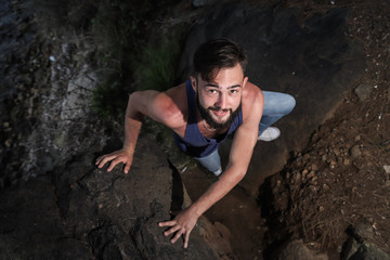 Handsome young man near sea on rocks in Turkey