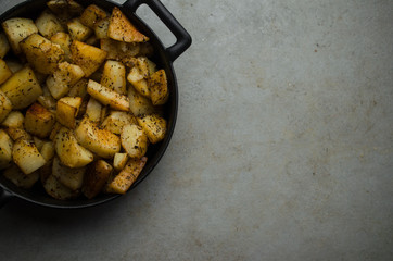 Baked potatoes in skillet