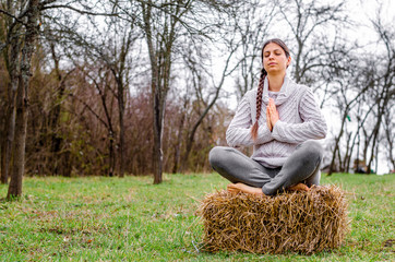 Young woman practicing yoga and meditation in the nature