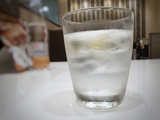 Close Up of fresh water in a glass on white table in restaurant, space for your text