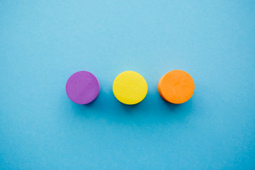 Yellow, orange and purple circle in the center on a blue background, abstraction