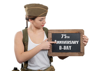 young woman dressed in american ww2 military uniform showing chalkboard with d-Day anniversary