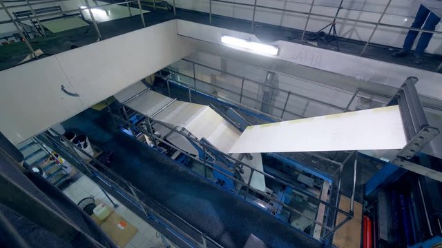 Printing factory with an industrial mechanism printing fresh newspaper.