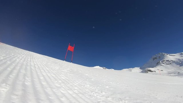 4K professional ski racer skiing one turn of giant slalom