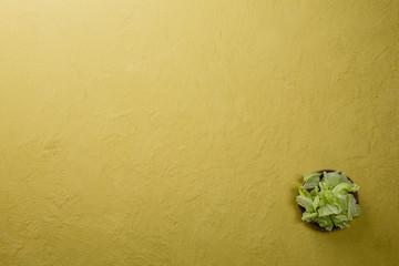 Iceberg lettuce leaf head on yellow table. Top view. Copy space.