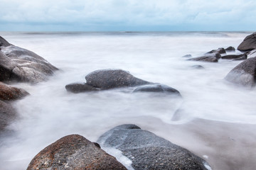 Obraz premium Long exposure shot.Sea scape with stone beach at sunset,Motion blur,slow shutter speed.
