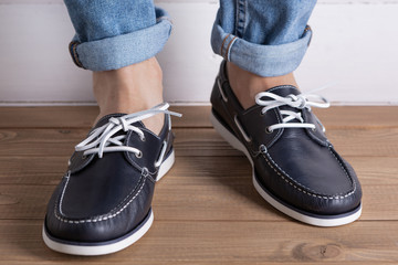 men's legs in blue shoes, comfortable summer moccasins, concept