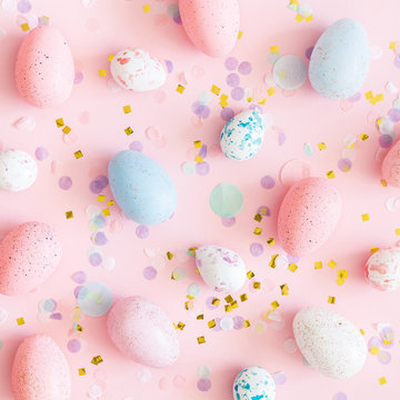 Easter composition. Easter eggs, confetti on pastel pink background. Flat lay, top view, square