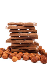 Chocolate tiles and nuts on white background