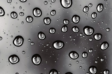water drops on the glass. rainy day. macro drops with reflection.
