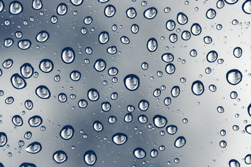water drops on blue background. macro drops with reflection.