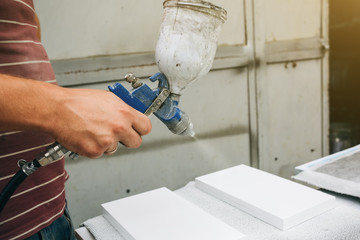 Man is holding airbrush spray vaporizer for painting and dyeing. Worker maintenance repairing of the house or apartment.