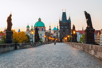 Obraz premium Scenic view on Vltava rive, Charles bridge and historical center of Prague, buildings and landmarks of old town at sunset, Prague, Czech Republic