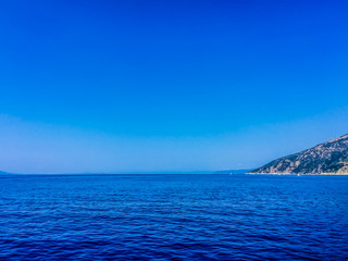Naklejka na ściany i meble Scenic View Of Sea Against Clear Blue Sky