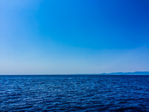 Scenic View Of Sea Against Clear Blue Sky