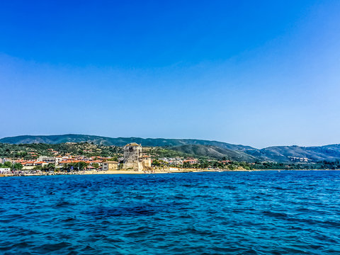 Scenic View Of Land And Sea Against Clear Blue Sky