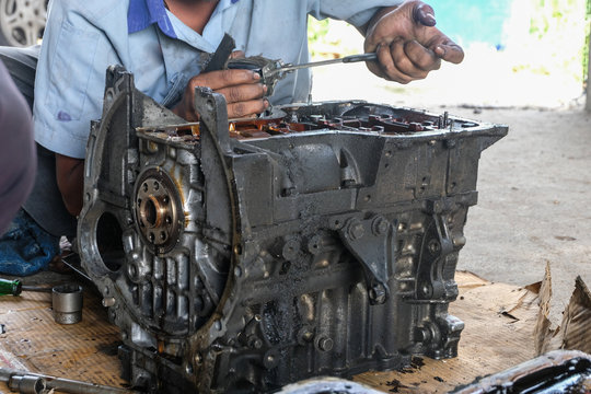 Guys are repairing the engine.