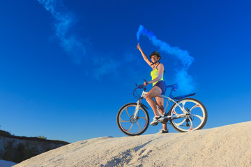 Fototapeta na wymiar Young sporty woman with a bike, soft focus background