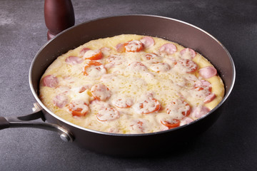 fresh pizza with hard cheese and cherry tomatoes and herbs