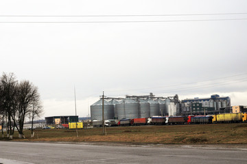 Fototapeta na wymiar trucks in a line and granary plant