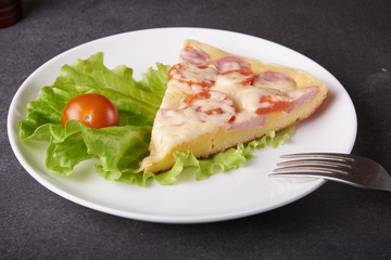 Fototapeta na wymiar fresh pizza with hard cheese and cherry tomatoes and herbs