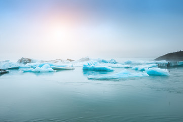 Blue icebergs in Jokulsarlon glacial lagoonat sunset, Iceland