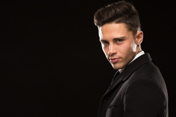 Close up portrait of a handsome professional secret service agent looking to the camera over his...