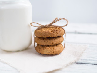 oatmeal cookies with milk on wooden background