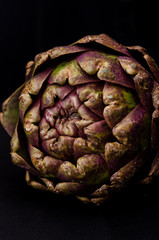 Obraz premium fresh purple artichokes on black background