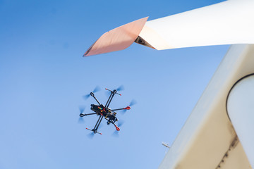 Industrial inspection drone takes high resolution photos of a wind turbine's rotor blades