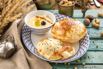 Fresh baked pasty filled with cheese paste on blue wooden table