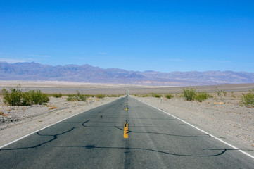 Straight road in the desert of Death Valley National Park, California USA