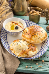 Fresh baked pasty filled with cheese paste on blue wooden table