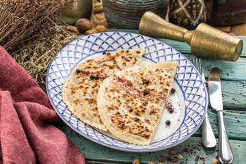 flat bread qutab on blue wooden table traditional Azerbaijani cuisine