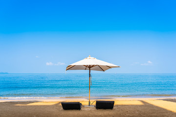 Chair umbrella and lounge on the beautiful beach sea ocean on sky