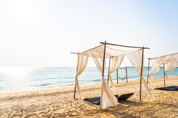 Chair umbrella and lounge on the beautiful beach sea ocean on sky