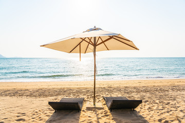 Chair umbrella and lounge on the beautiful beach sea ocean on sky