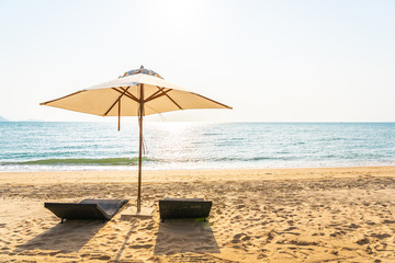 Chair umbrella and lounge on the beautiful beach sea ocean on sky