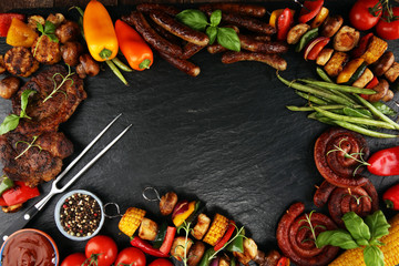 Assorted delicious grilled meat and skewer with vegetable on rustic table