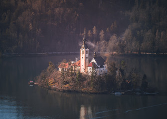 beautiful church in the lake bled, Slovenia during a foggy morning.  lake bled and its church are one of the most famous place in Europe.