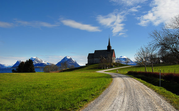 Ed&oslash;y Church on Sm&oslash;la with the mountains of Tustna in the background. The church is from 1190