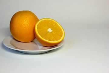 Isolated oranges on plate on white background