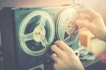 listening old records on vintage audio reel recorder