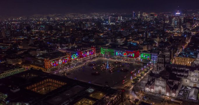 Aerial nocturnal hyperlapse of the main plaza of Mexico City know as El Zocalo with Christmas lights at night. Mexico City