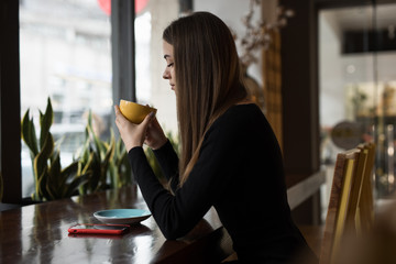 Woman having coffee break sitting in cafe