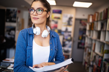 Portrait of young beautiful smiling woman working or studying