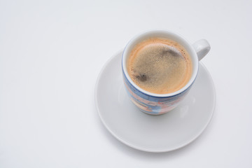 Strong espresso served in white cup and saucer