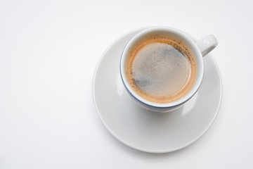 Strong espresso served in white cup and saucer
