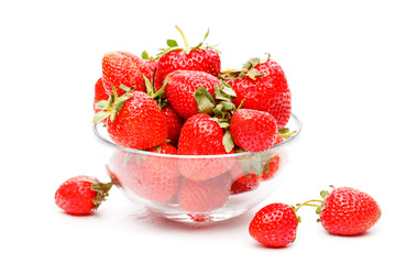 Image of green strawberry in glass cup on empty white background.