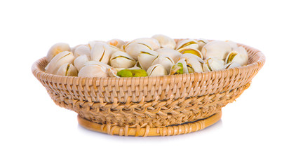 Pistachio nuts in basket on white background